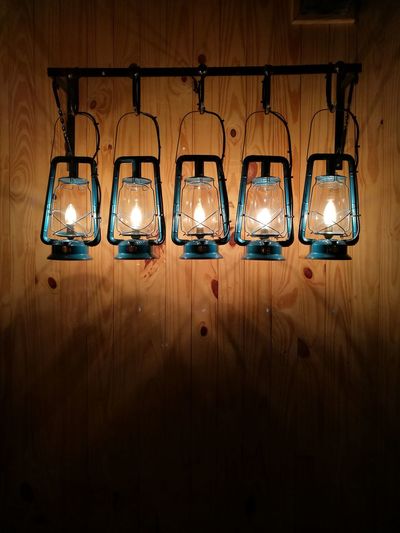 Illuminated lamps hanging in dark room