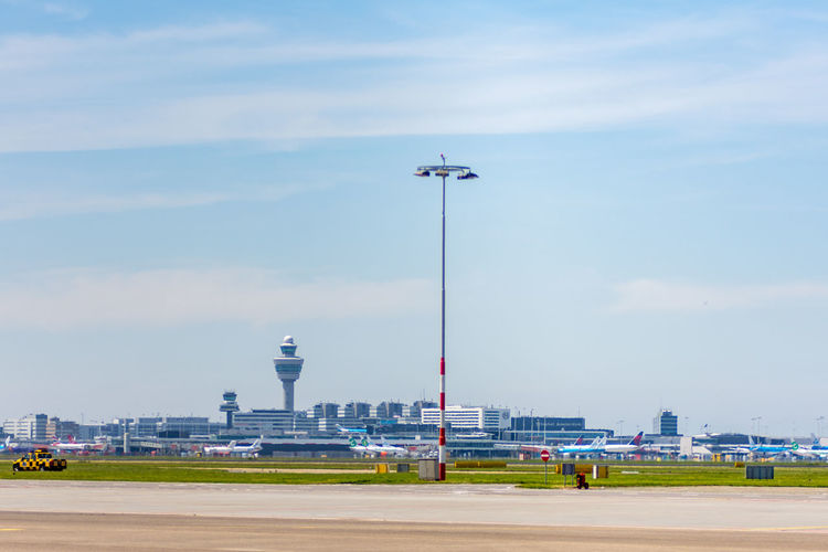 Floodlight at amsterdam schiphol airport against sky on sunny day