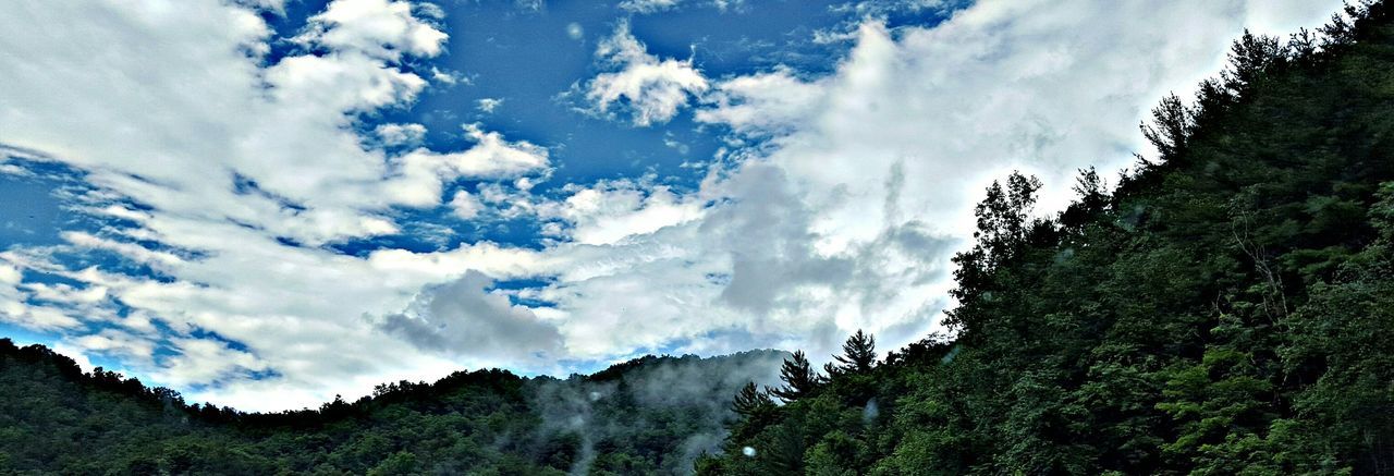 Scenic view of mountains against cloudy sky