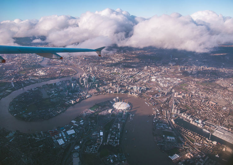 Cropped image of aircraft wing flying against sky