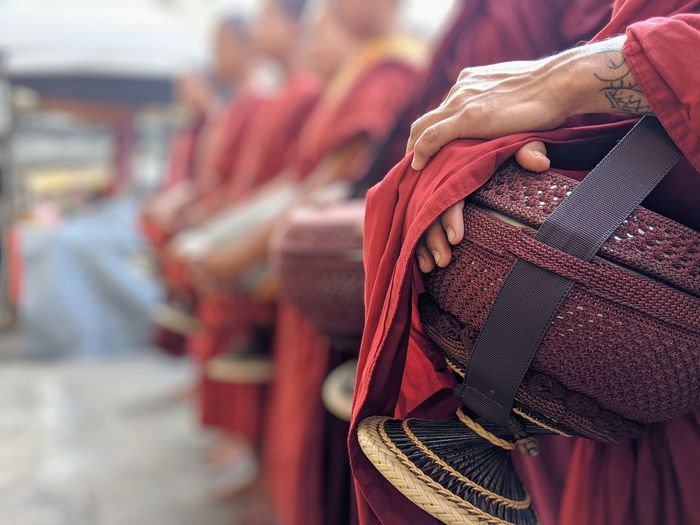 Close-up of novice buddhist monks hand holding religious equipment in buddha temple