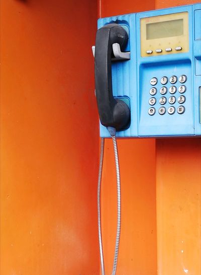 Close-up of payphone in telephone booth