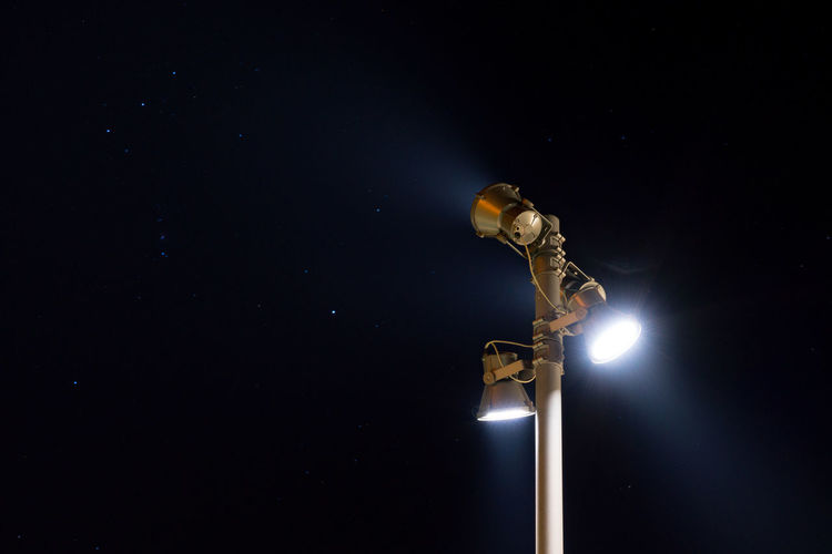 Close-up of illuminated street light against clear sky at night