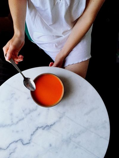 High angle view of woman eating soup