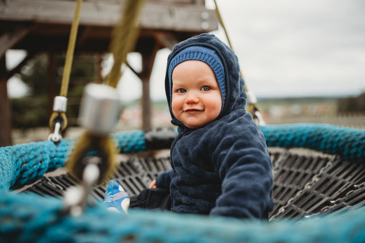 Cute baby boy at a playground during winter