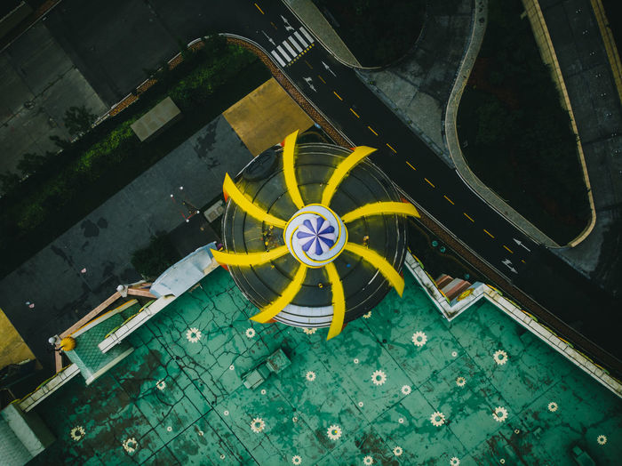 High angle view of yellow wheel spinning by street