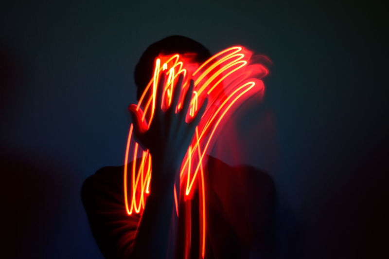 Digital composite image of light painting against black background