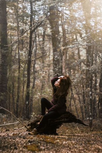 Woman sitting in forest