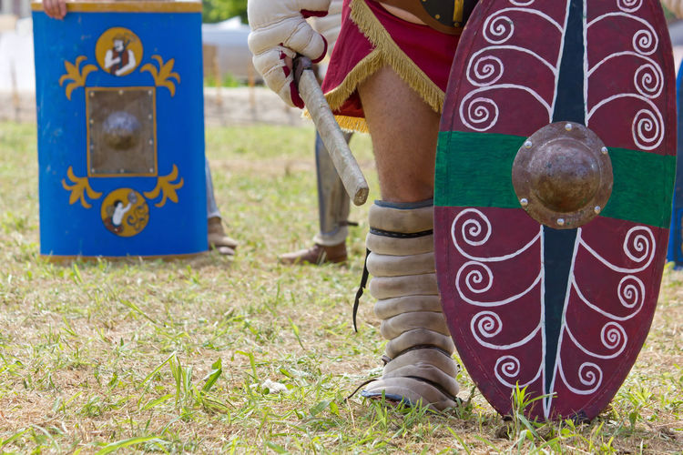 Low section of man standing on field