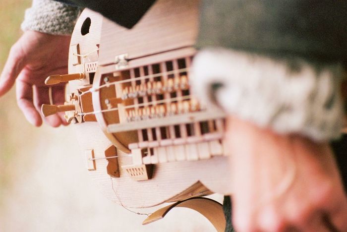 Cropped hands of person holding guitar