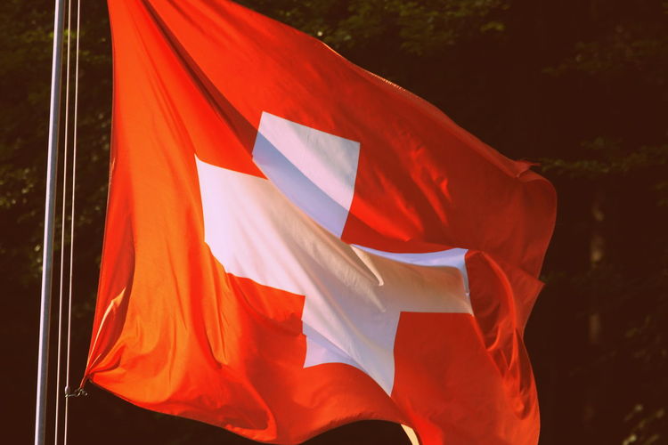 Close-up of swiss flag waving during sunny day