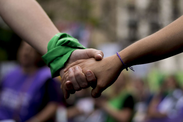 Close-up of people holding hands