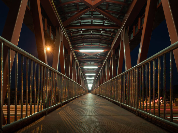Illuminated footbridge at night
