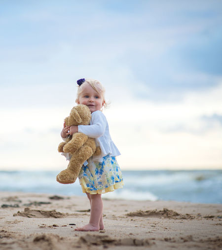 Full length of cute girl on beach