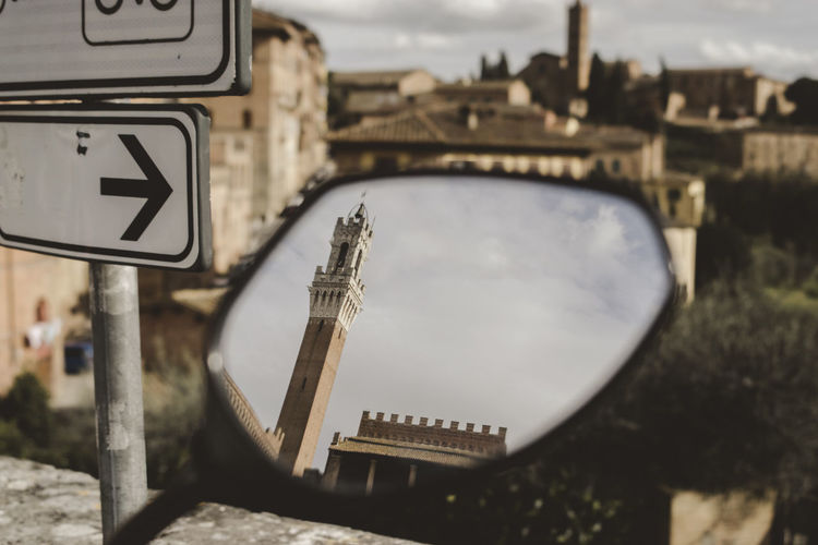Torre del mangia reflecting on vehicle mirror
