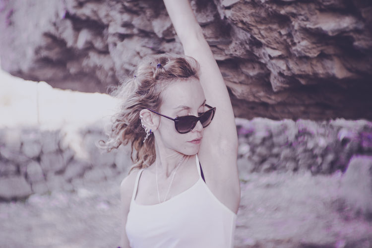 Young woman wearing sunglasses standing outdoors