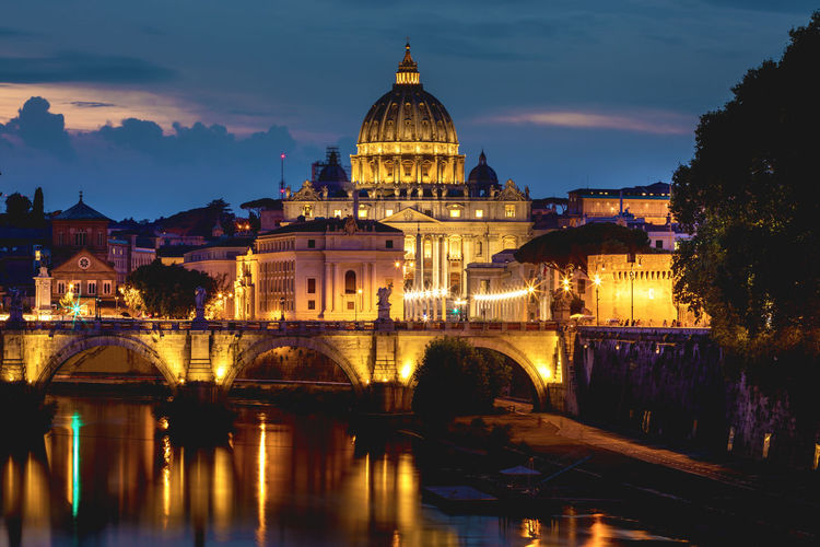 Ponte sant angelo over tiber river in city at night