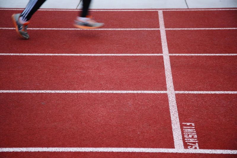 Low section of athlete running on track