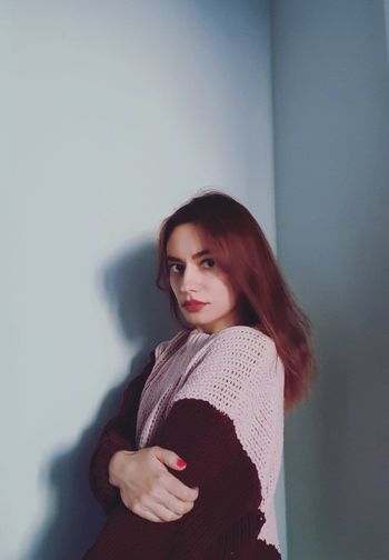 Young beautiful woman in a pink knitted sweater