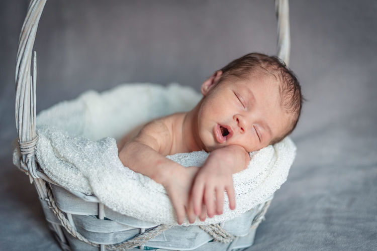 Cute baby boy sleeping in bed
