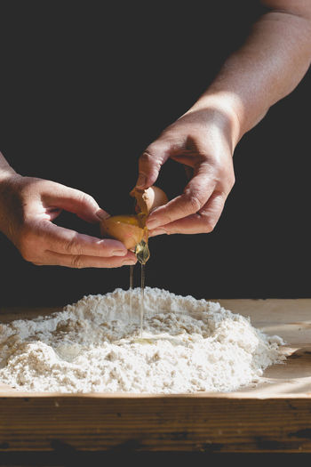 Close-up of hands preparing dough