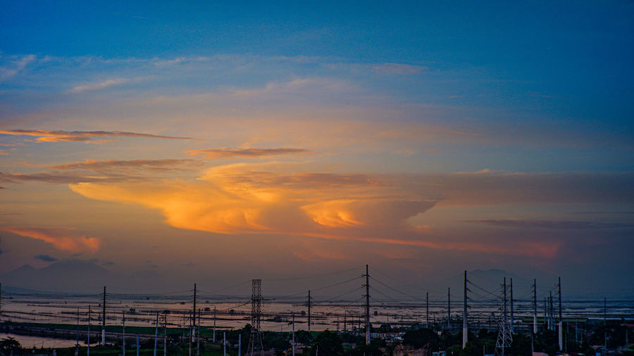 Scenic view of dramatic sky over city during sunrise