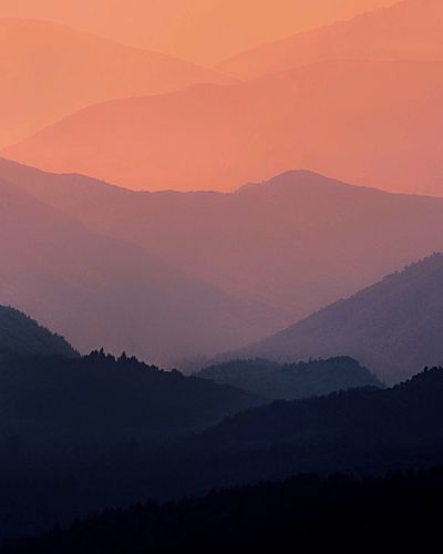 Scenic view of silhouette mountains against sky during sunset