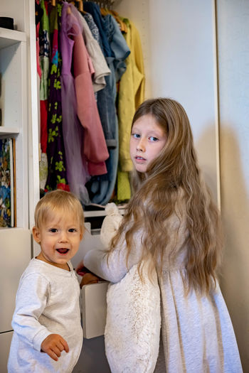 Portrait of cute girl standing at home