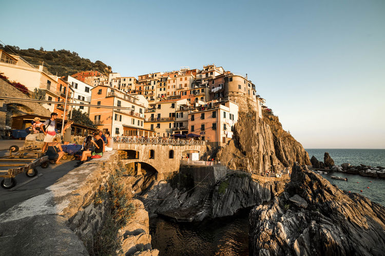 Houses on rock formation at manarola against clear sky