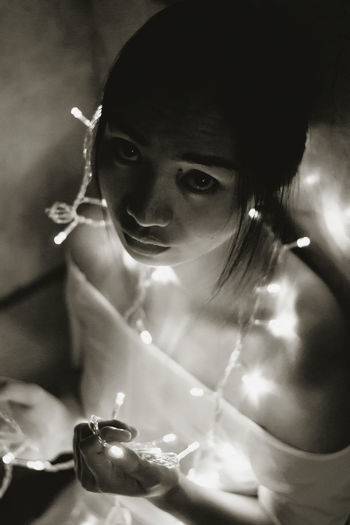 Portrait of woman with fairy lights