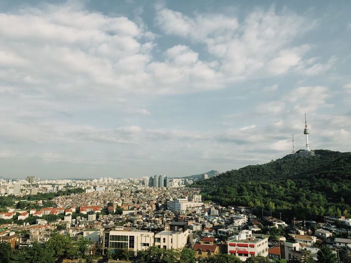High angle view of cityscape against cloudy sky