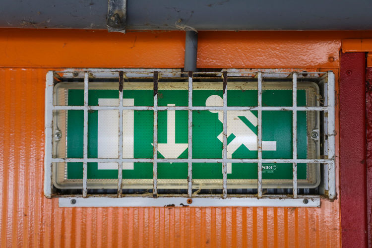 Close-up of exit sign on wall