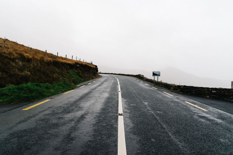 Misty lonely road in the wild atlantic way of ireland