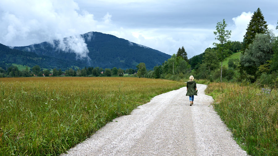 Solitary woman hikes in the bavarian foothills