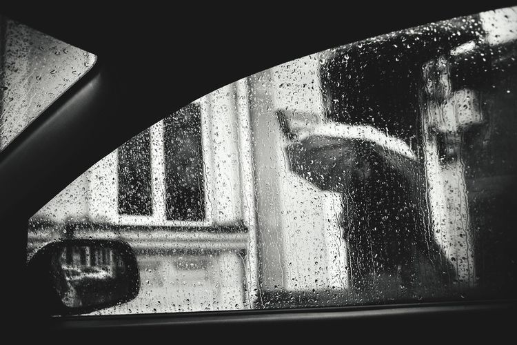 Close-up of car window during rainfall