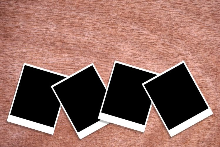 High angle view of instant print transfers on wooden table