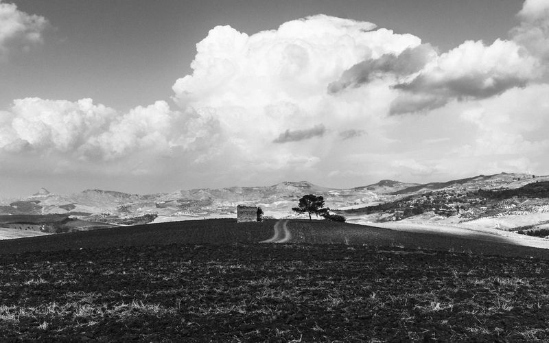 Panoramic view of people on land against sky
