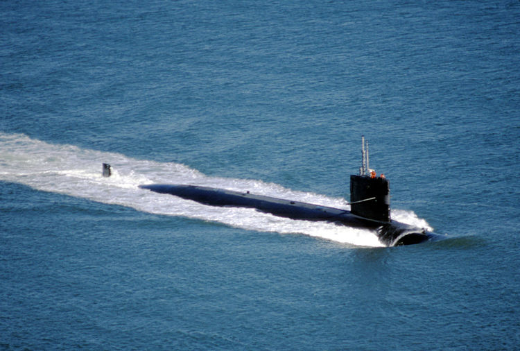 High angle view of navy submarine in sea against sky