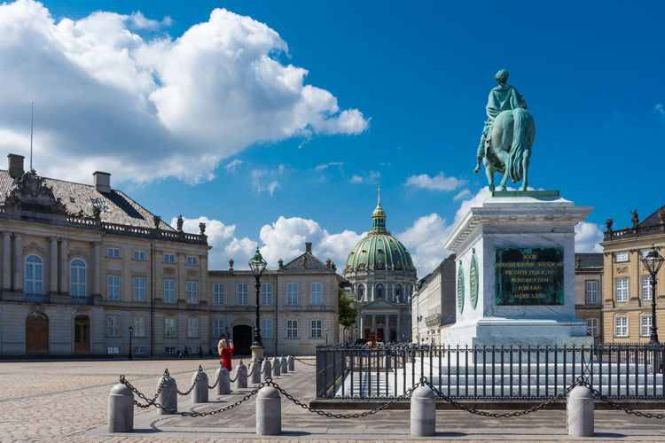Statue of historic building amalienborg palace against sky