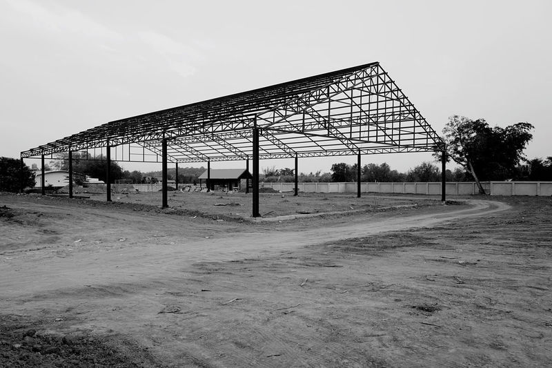 Built structure on field against sky
