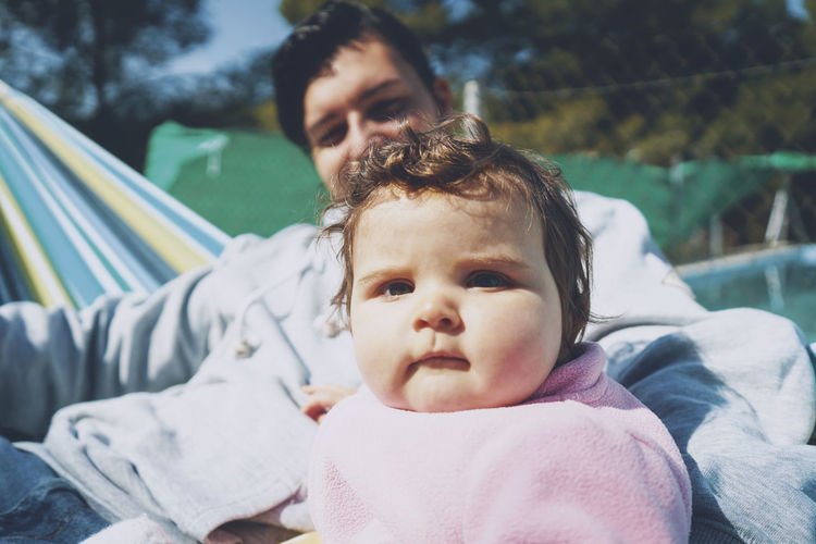 Portrait of mother cute baby with father outdoors