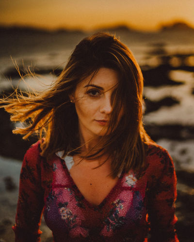 Portrait of beautiful young woman during sunset