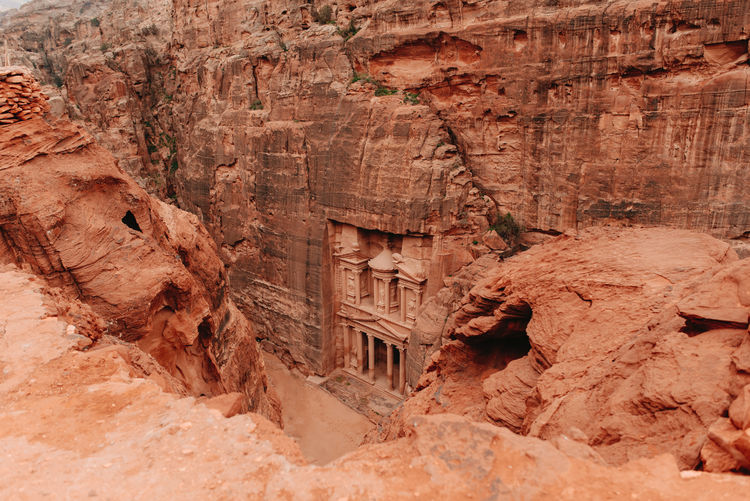 From above of ancient al khazneh temple carved out of sandstone cliff located in lost city of petra