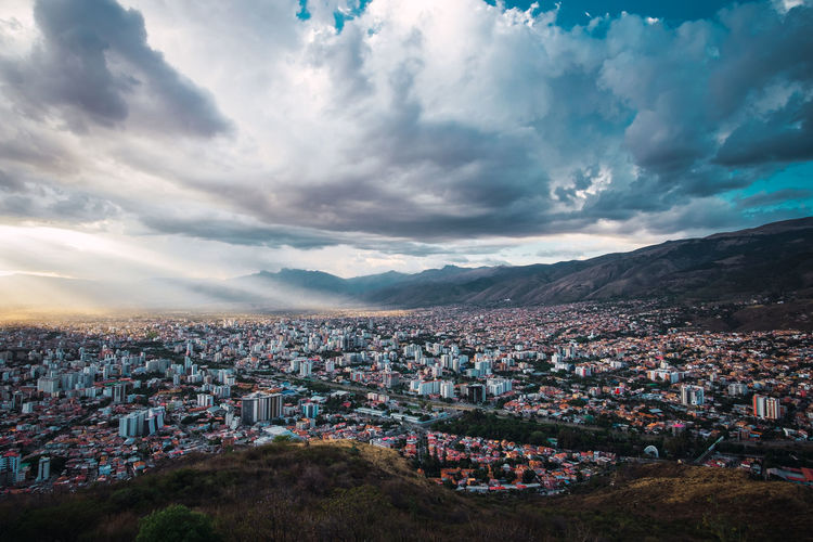 Areal view of cochabamba, bolivia with cloudy skys and rays of sunlight. located in south america