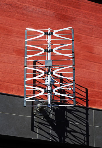 High angle view of metal railing against red wall