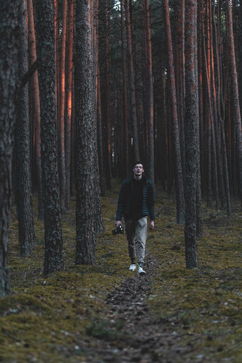 Full length of man walking in forest