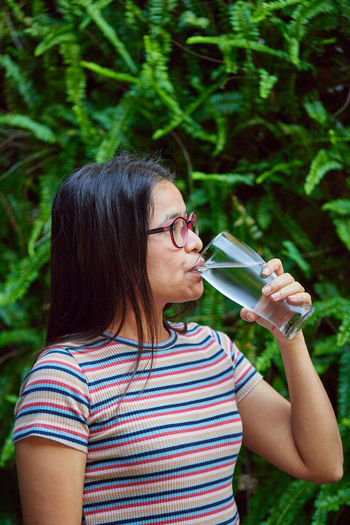 Woman drinking water from a glass of water