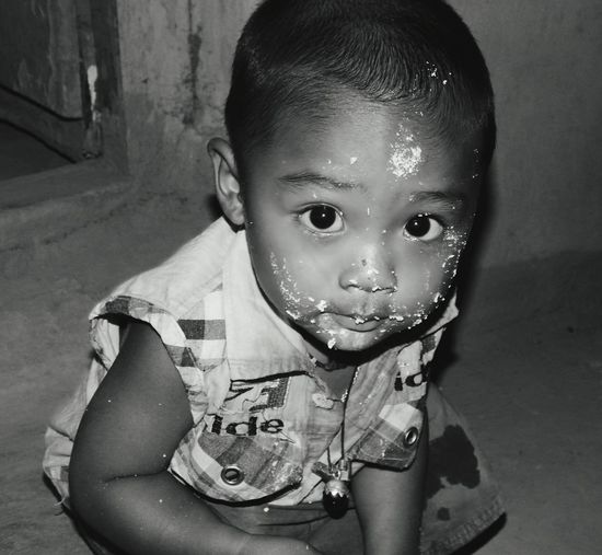 Close-up portrait of boy with food on face