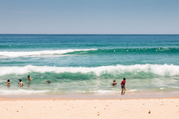 People on beach against sky