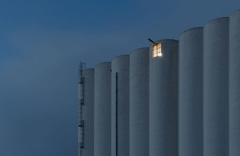 Low angle view of factory against sky during night